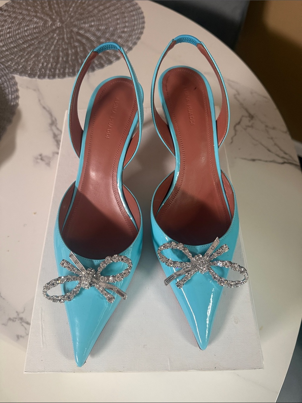 Amina Muaddi Turquoise Patent Slingback Pumps with Crystal Bow